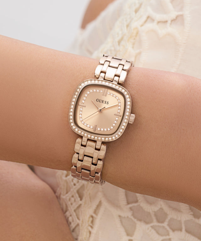 Rose Gold watch with diamond accents on a wrist against a neutral background