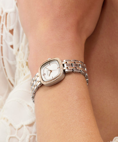 GUESS Ladies Hazel 2-Tone Analog Watch on a wrist with a neutral background