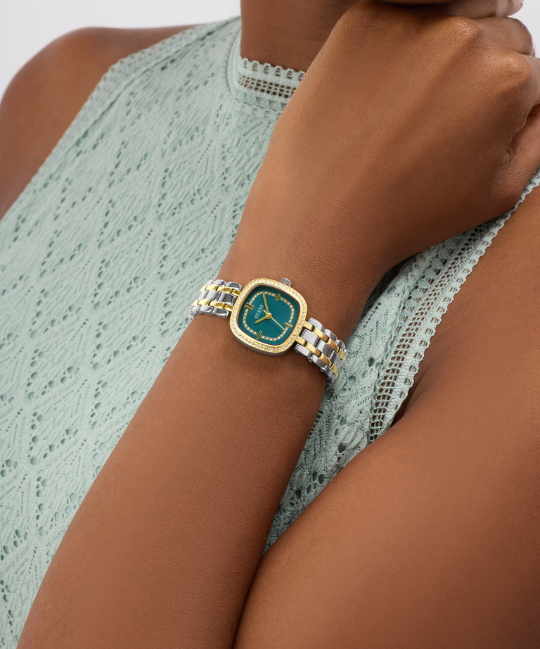 GUESS Ladies Hazel 2-Tone Analog Watch on a wrist with a light green lace top