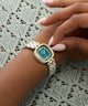 GUESS Ladies Hazel 2-Tone Analog Watch on a wrist with a lace background