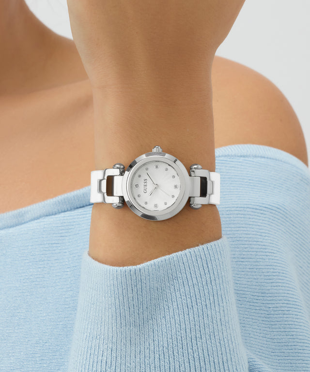 Silver watch on a wrist with a light blue sweater
