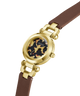 A GUESS women's watch featuring a gold-tone round case, a tortoiseshell-patterned dial with crystal hour markers, and a brown leather strap, shown on a solid white background. lifestyle
