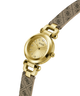 Gold watch with a patterned strap on a white background lifestyle