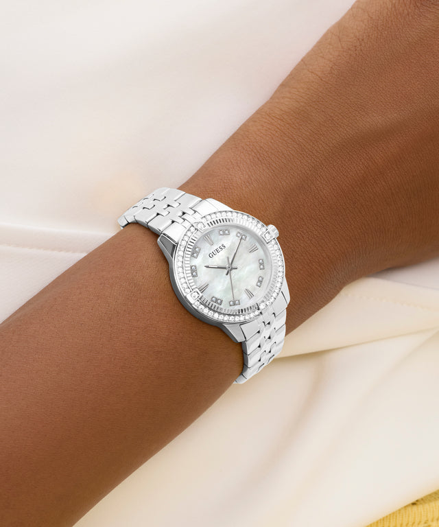 Silver watch on a wrist with a white background
