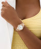 GUESS Ladies Colette Rose Gold Tone Analog Watch on a wrist with a yellow top