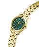 Gold watch with a green dial on a white background lifestyle