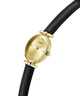 Gold and black watch with Guess logo on a white background lifestyle