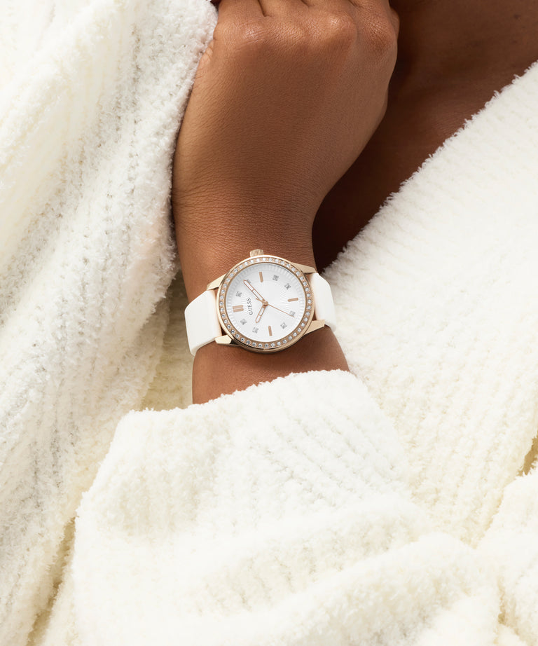 White watch on a wrist with a white textured background