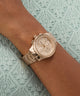 Rose gold GW1031L4 on a wrist with a textured green background