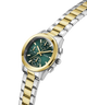 Two-tone gold and silver watch with a green dial on a white background lifestyle