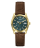 A Guess wristwatch with a gold-tone fluted bezel, dark green dial, and brown alligator-textured strap, shown against a plain white background.
