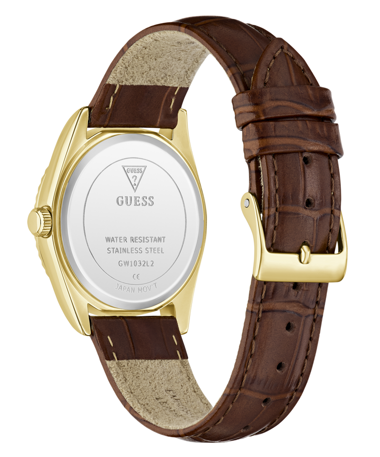 The back view of a GUESS wristwatch with a brown leather strap, gold-tone case, and white back cover showing the brand name and specifications.