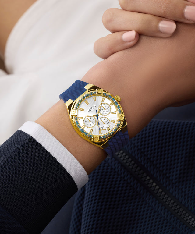 GUESS Ladies Blue Gold Tone Analog Watch on wrist