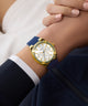 GUESS Ladies Blue Gold Tone Analog Watch on wrist