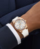 GUESS Ladies White Rose Gold Tone Analog Watch on a wrist