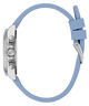 Close-up of a GUESS Ladies Ice Blue Silver Tone Analog Watch with Swarovski ReCreated™ crystals with a light blue strap on a white background