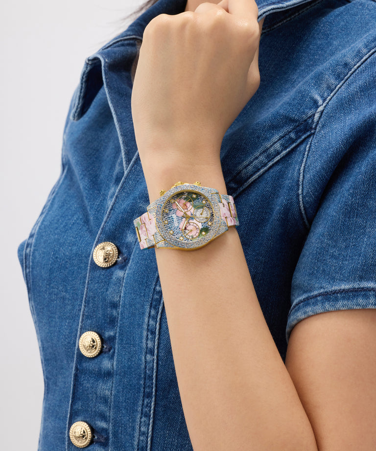 Person wearing a decorative GUESS Ladies Blue Analog Watch on a denim jacket background