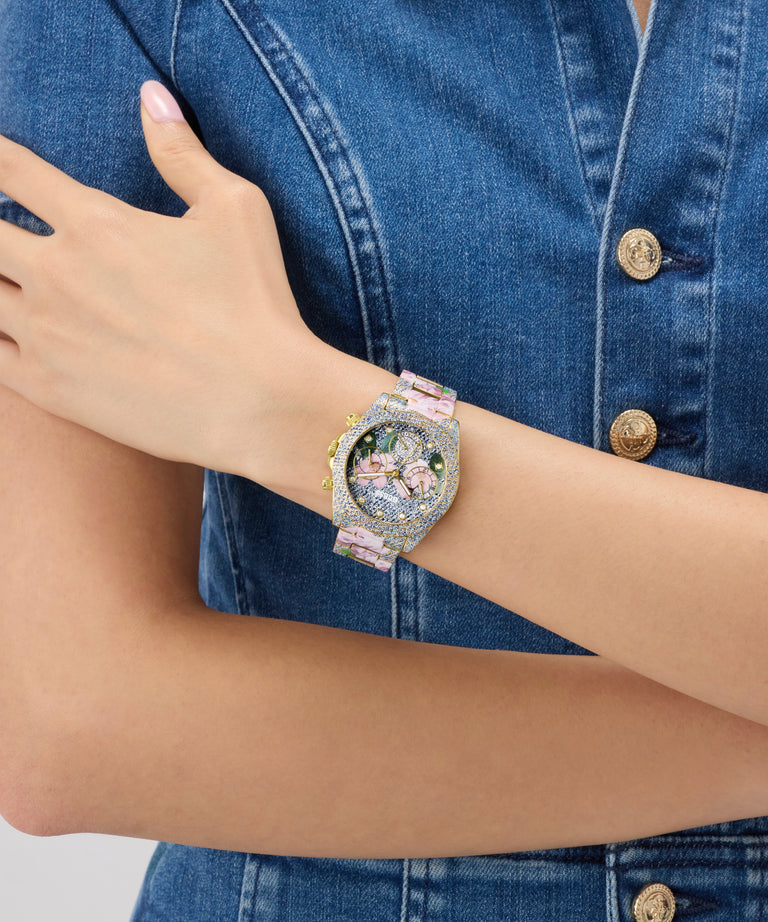 Person wearing a decorative GUESS Ladies Blue Analog Watch on a blue denim background