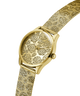 Gold watch with floral design on the face against a white background lifestyle