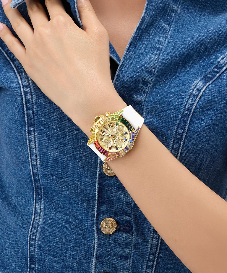 Gold GUESS Ladies Pride Limited Edition White Gold Tone Analog Watch with colorful accents on a wrist against a denim background