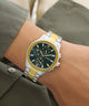 Two-tone GUESS Mens Palmer 2-Tone Analog Watch on a wrist with a neutral background