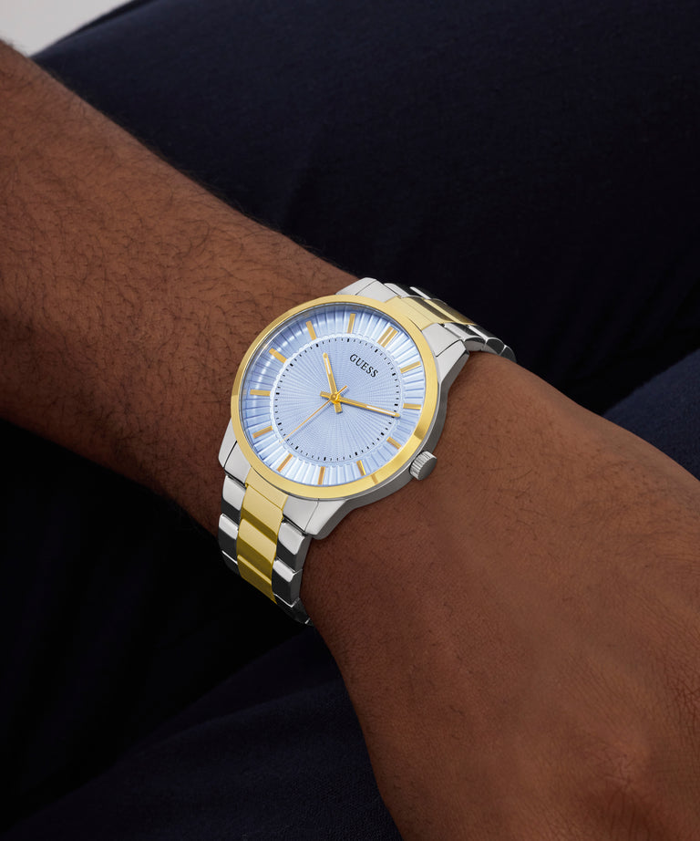 Two-tone watch on a wrist with a dark background