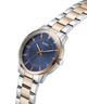 Guess watch with silver and rose gold band on a white background lifestyle