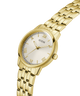 Gold watch with a white face and 'GUESS' branding on a transparent background lifestyle