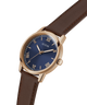 Guess watch with brown leather strap and blue dial on a white background lifestyle