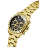 Gold GUESS Mens Gold Tone Analog Watch with a black face on a white background lifestyle