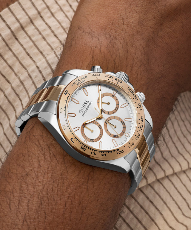 Silver and gold GUESS Mens Arthur 2-Tone Analog Watch on a wrist with a neutral background