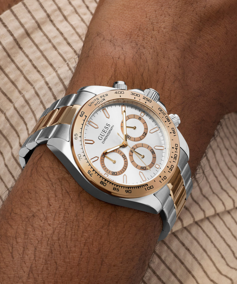 Silver and gold GUESS Mens Arthur 2-Tone Analog Watch on a wrist with a neutral background