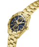 Gold watch with a blue face on a white background lifestyle