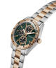 Two-tone watch with green dial and gold accents on a white background lifestyle