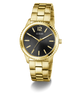 Gold GUESS Mens Gold Tone Analog Watch with black dial on a white background