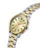 Two-tone gold and silver watch with green accents on a white background lifestyle