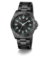 Black Guess watch with green accents on a white background