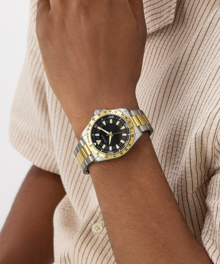 Two-tone watch on a wrist with a neutral background