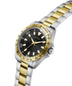 Two-tone silver and gold watch with black dial on a white background lifestyle