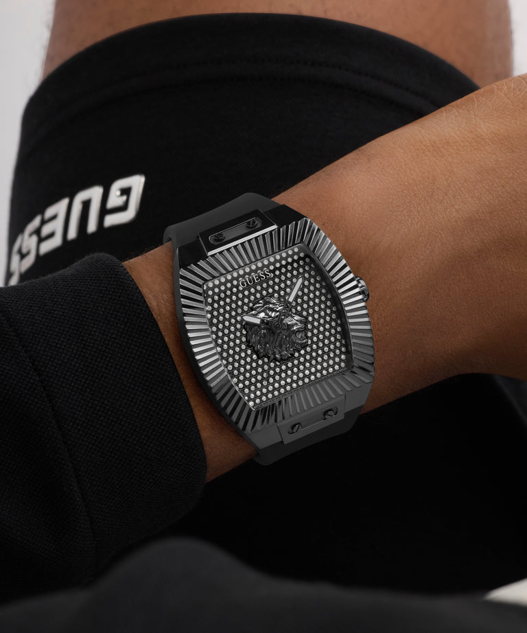 Black textured watch on a wrist with a blurred background