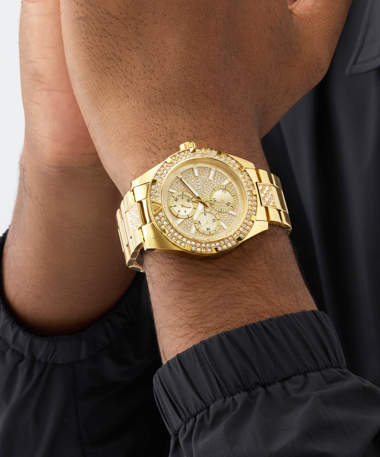 Gold wristwatch on a person's wrist with a black sleeve