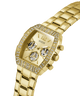 Gold GUESS Mens Gold Tone Analog Watch with gemstone accents on a white background lifestyle