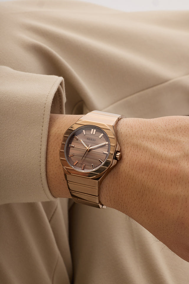 GUESS Mens Jaq Coffee Analog Watch on a wrist with a beige background