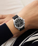 Black GUESS Mens Palmer Black Silver Tone Analog Watch with silver case on a wrist against a neutral background