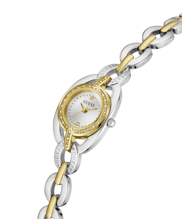 A Guess women's two-tone watch with a silver and gold-tone link bracelet, a silver-toned oval case, and a gold-tone bezel accented with small clear crystals. The white dial features gold-tone hands and hour markers. lifestyle
