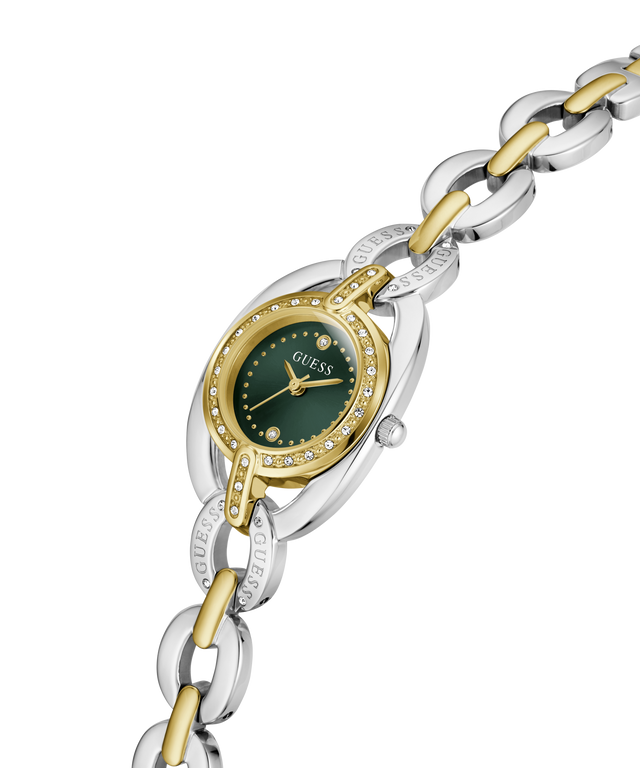 A Guess women's two-tone watch with a silver and gold-tone link bracelet, a silver oval case, and a dark green dial accented with small clear crystals. lifestyle
