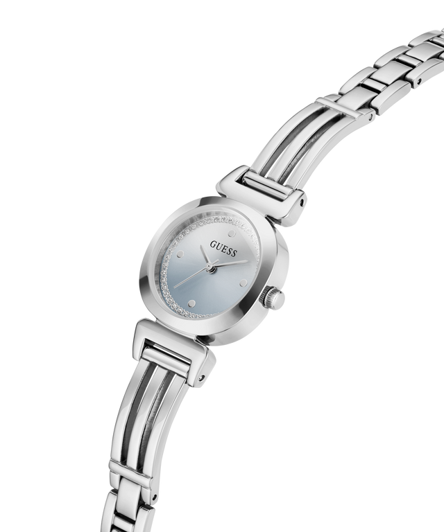 A silver-tone stainless steel women's watch by Guess, featuring a round silver case, a light blue dial, and a matching silver link bracelet, shown against a plain white background. lifestyle