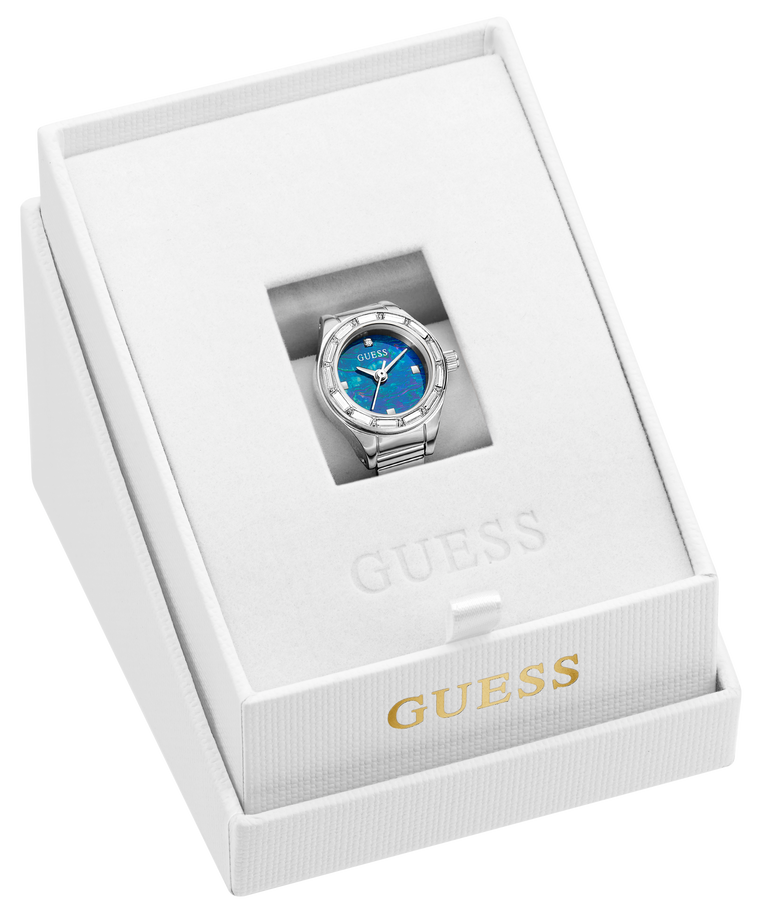 A Guess wristwatch ring with a blue dial and silver-tone case and bracelet, presented inside an open white Guess gift box with gold branding.