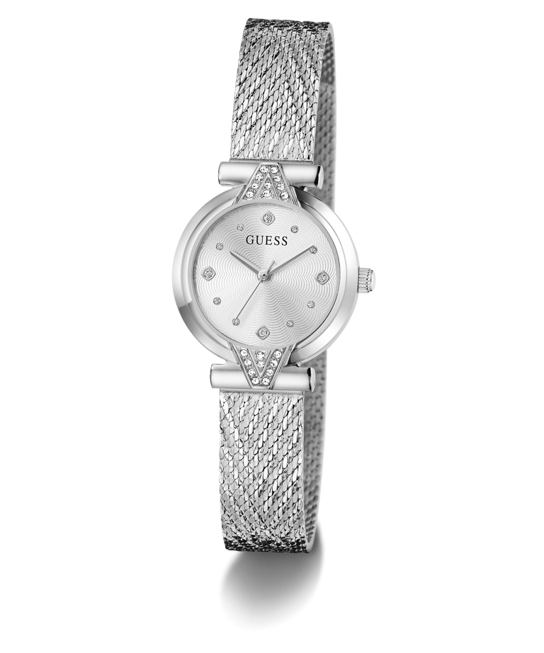 A silver-tone wrist watch with a mesh strap, round dial, and crystal embellishments, shown on a clean white background. The brand name 'GUESS' is visible on the dial.