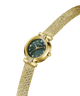 A gold-tone Guess watch with a green sunburst dial and a matching gold mesh bracelet, shown on a clean white background. lifestyle
